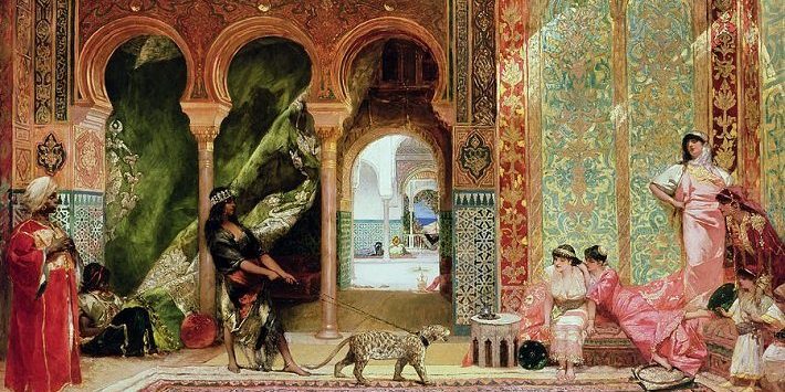 a-royal-palace-in-morocco-benjamin-jean-joseph-constant Eight people dressed in silk and gold jewelry lounge in front of the backdrop of opulent palace walls. One figure in the center is walking a leopard on a leash.