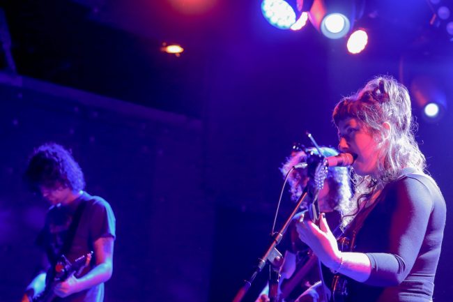 Wednesday-1 Karly Hartzman on stage with band members Ethan Baechtold and MJ Lenderman